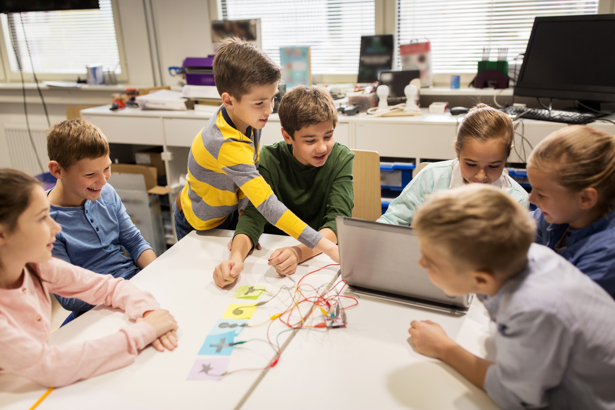 kids, laptop and invention kit at robotics school