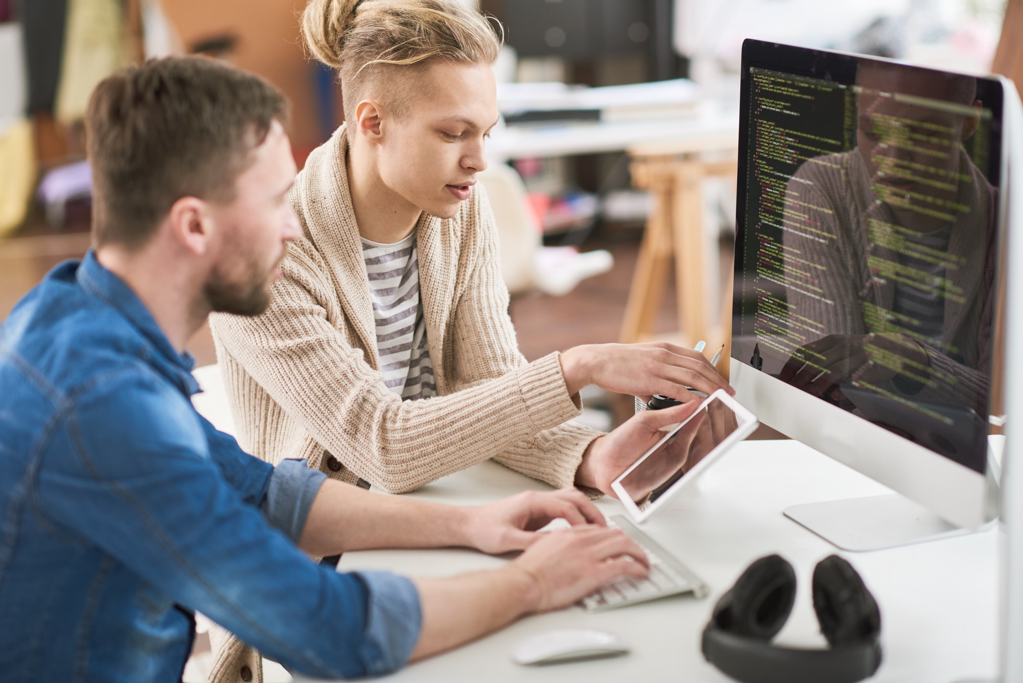 Two Young Men Writing Code